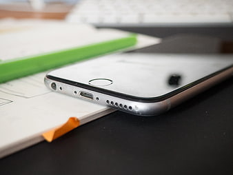 Close-up of Smartphone on Notebook with Green Pencil