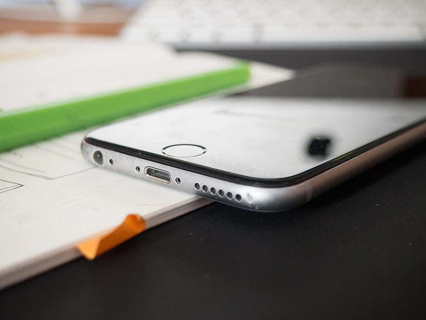 Close-up of Smartphone on Notebook with Green Pencil
