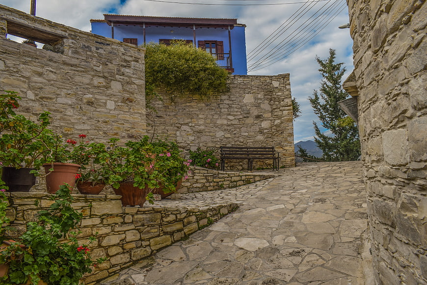 Stone Pathway in Traditional Village with Blue House