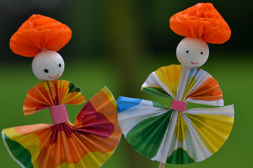 Colorful Paper Dolls with Pleated Skirts and Orange Hats