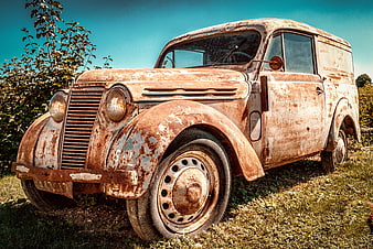 Rusty vintage Renault Juvaquatre van in field