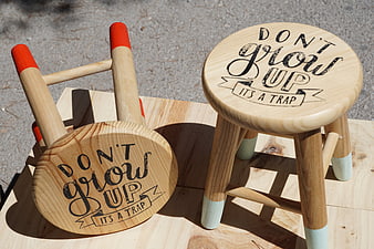Wooden Stools With Don't Grow Up It's A Trap Text