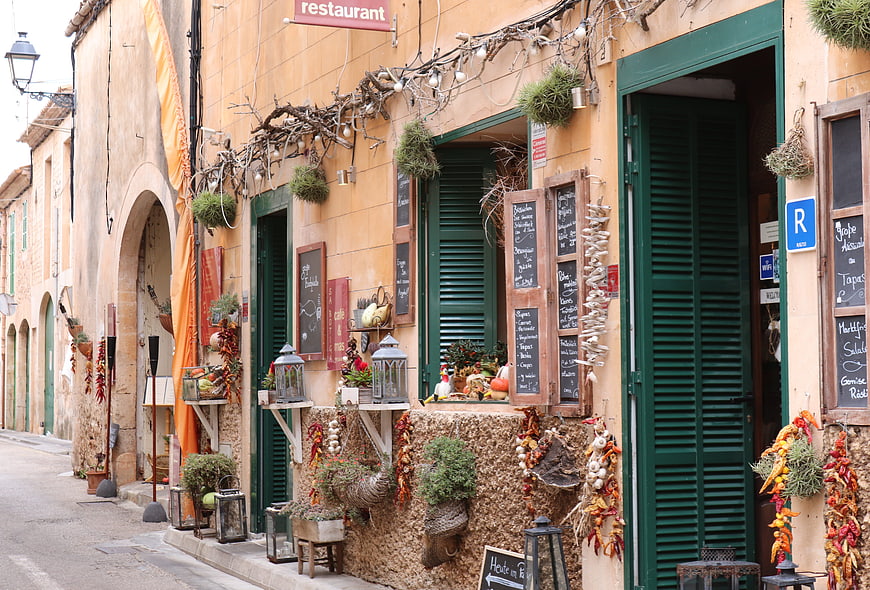 Charming Mediterranean Restaurant Facade with Green Shutters