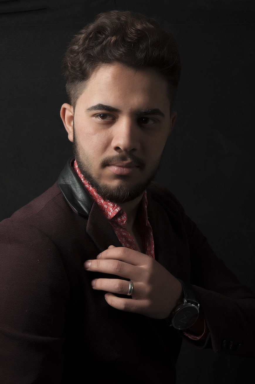 Portrait of stylish man in burgundy jacket and red shirt