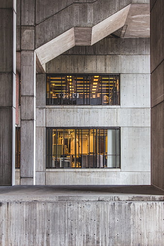 Modern Brutalist Concrete Building Facade with Lit Windows