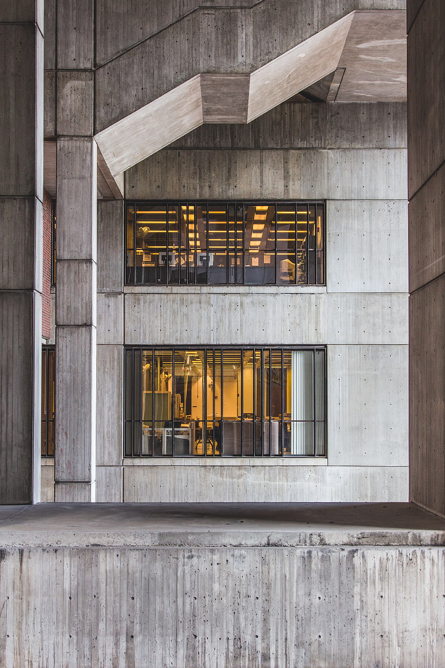 Modern Brutalist Concrete Building Facade with Lit Windows