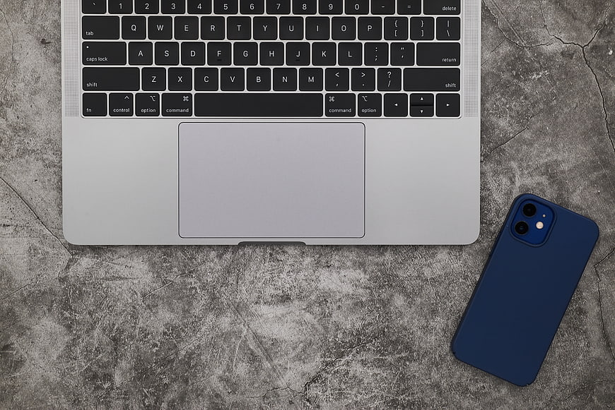Top view of laptop and smartphone on concrete workspace