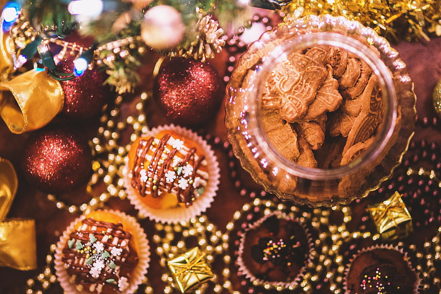 Overhead view of Christmas cookies and festive holiday decorations