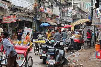 Busy street scene in Delhi India with rickshaws and vendors