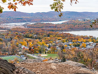 Autumn Landscape View of Town, River, and Rolling Hills