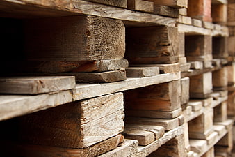 Stacked Wooden Pallets in Industrial Warehouse Storage