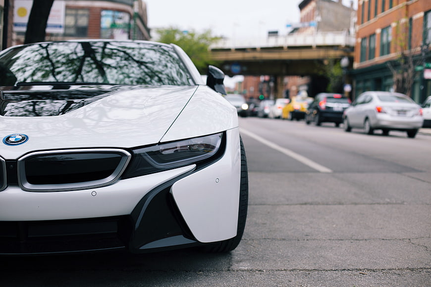 White BMW i8 sports car parked on city street