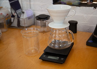 White ceramic pour-over coffee dripper on scale