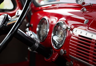 Close-up of red vintage Chevrolet dashboard and steering wheel