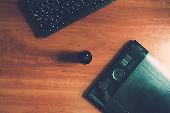 Top View of Keyboard and Graphics Tablet on Wooden Desk