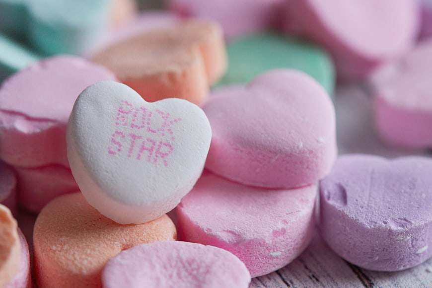 Close-up of pastel conversation hearts candy with Rock Star message