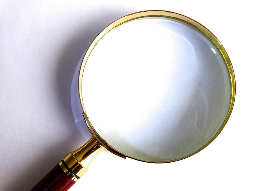 Gold Magnifying Glass on White Background