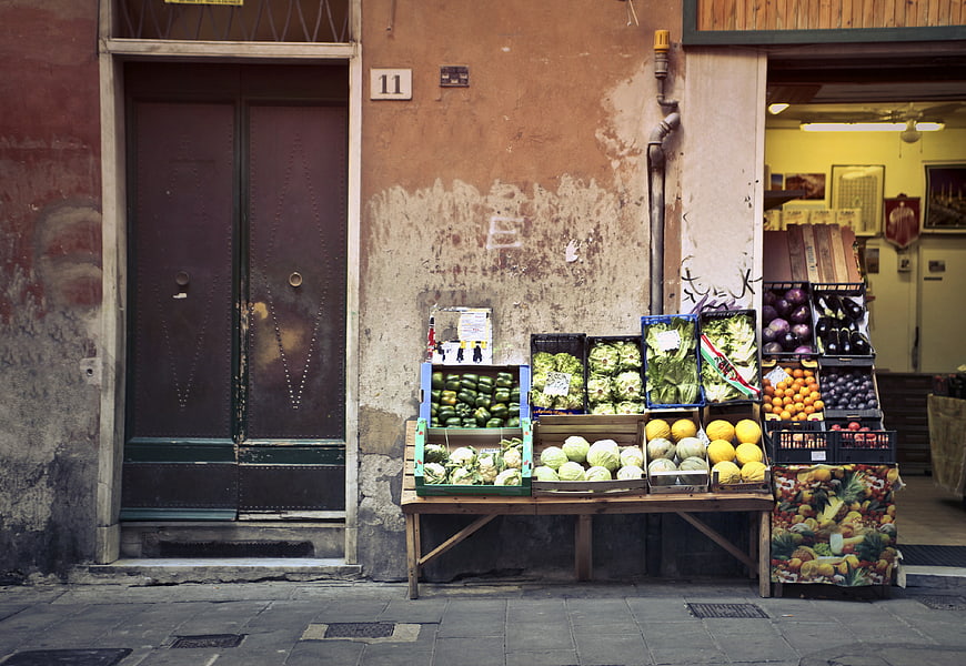 Fresh produce display outside rustic European street market shop