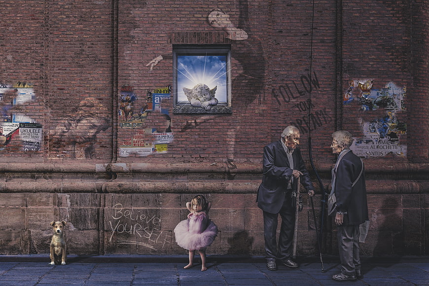 Elderly couple and young ballerina on urban street with dog