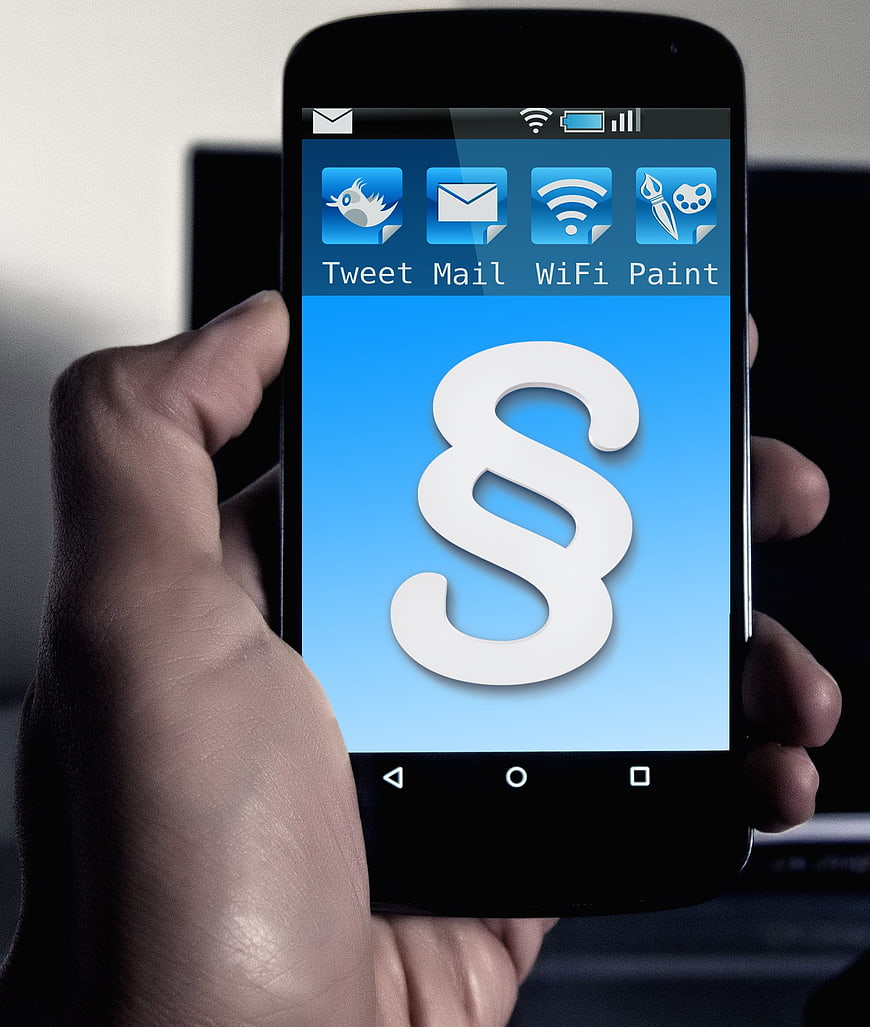 Hand holding smartphone with blue app interface screen