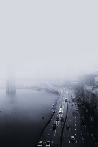 Foggy Highway Traffic Overlooking River in City