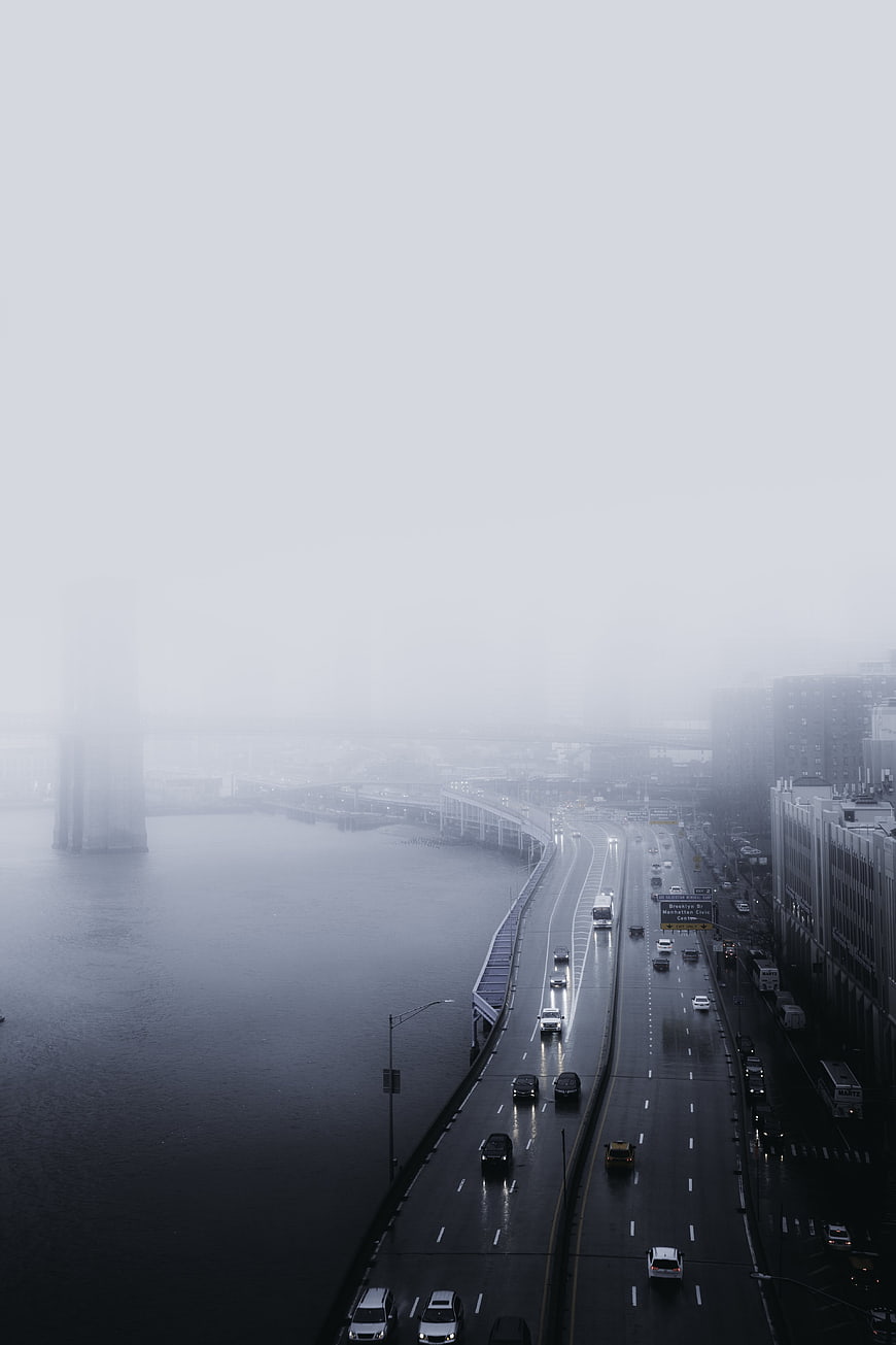 Foggy Highway Traffic Overlooking River in City