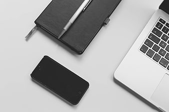 Minimalist Workspace with Laptop, Smartphone, and Notebook