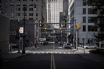 Urban Street Intersection With Traffic Lights And City Buildings