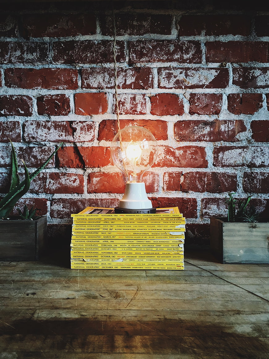 Vintage Edison Bulb on Stack of National Geographic Magazines