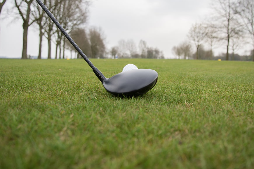 Golf Driver and Ball on Green Fairway Grass