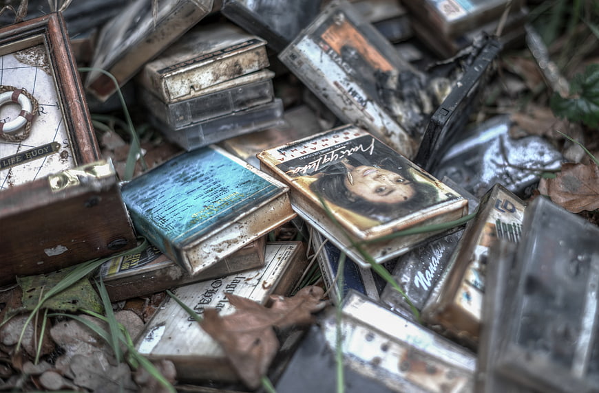 Pile of old dirty cassette tapes in the grass