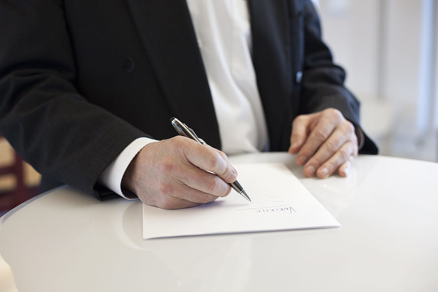Businessman signing a contract with a pen