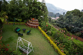 Lush garden terrace with swing and mountain view