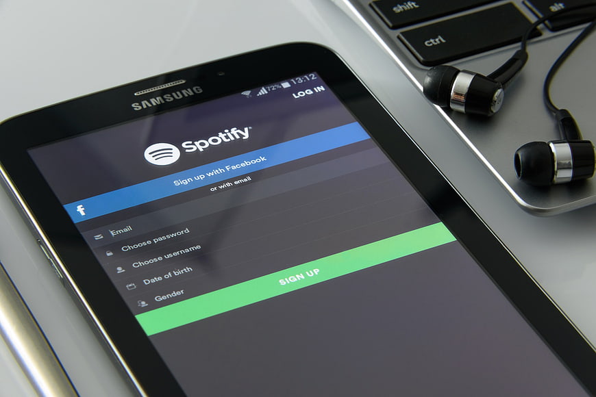Samsung Tablet Displaying Spotify Sign Up Screen with Headphones
