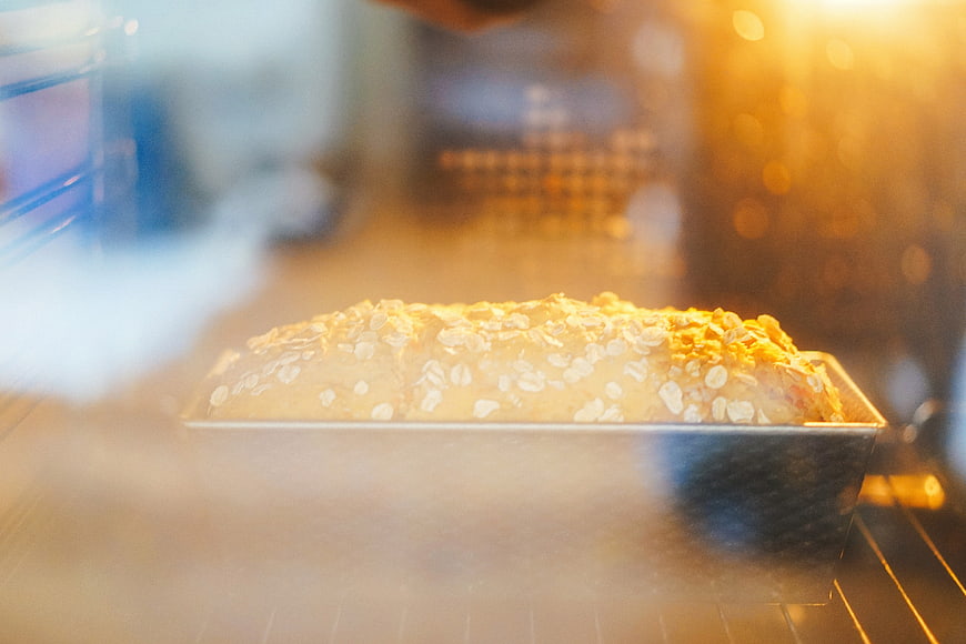 Loaf of Bread Baking in Oven with Steam