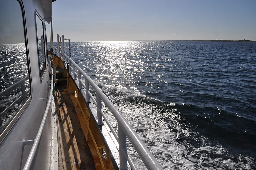 Side view of boat deck on sparkling blue water