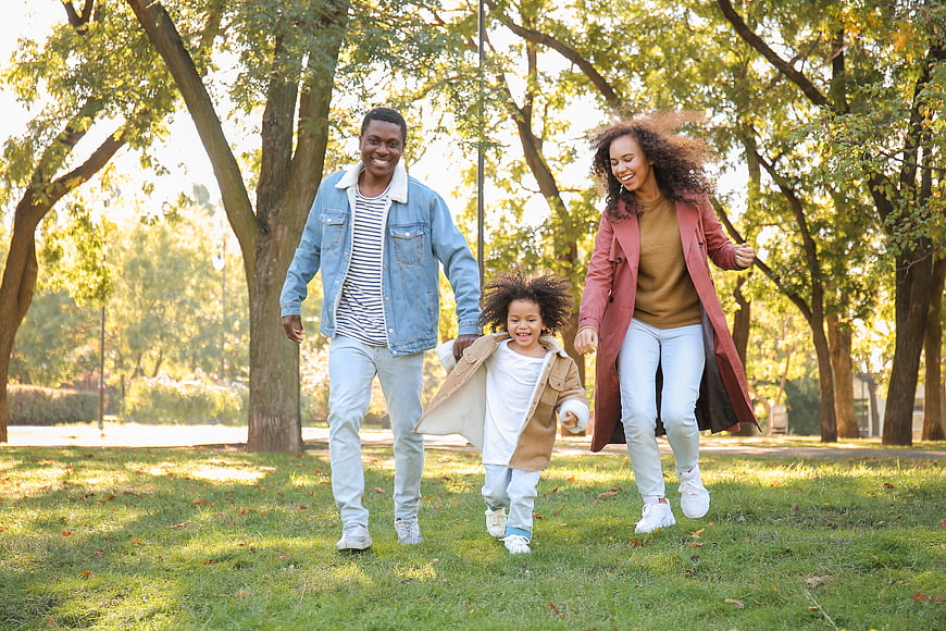 Happy African American Family Running in Park