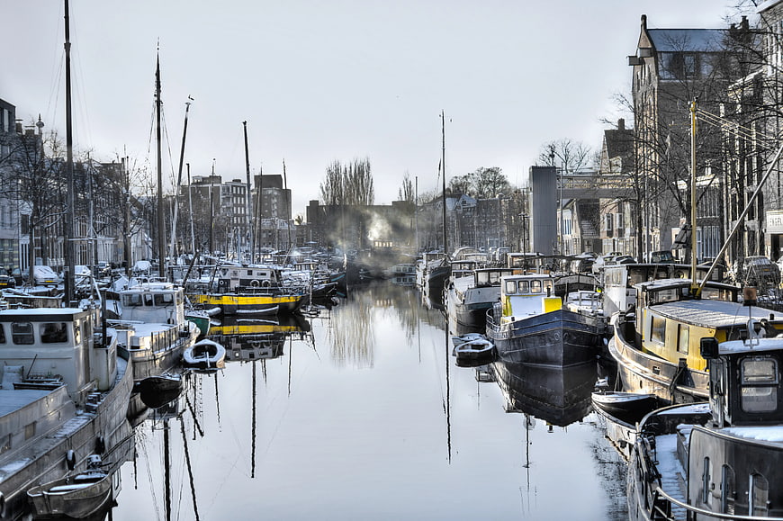 Snowy Canal with Moored Boats in Winter City