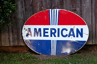Vintage American Gas Station Sign on Wooden Fence