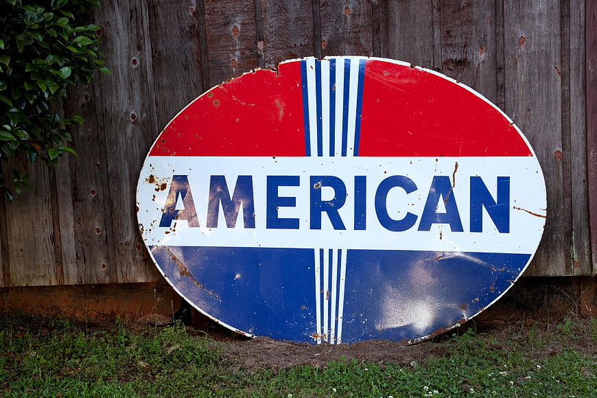 Vintage American Gas Station Sign on Wooden Fence