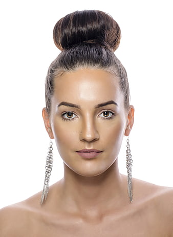 Studio Portrait Of Woman With High Bun And Silver Earrings