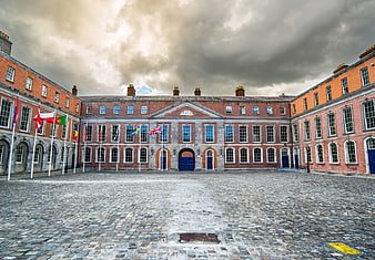 Dublin Castle Courtyard with International Flags and Cobblestones