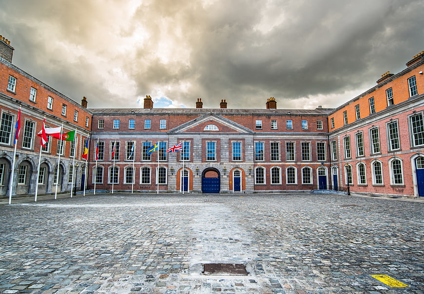 Dublin Castle Courtyard with International Flags and Cobblestones