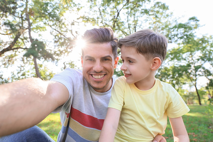 Happy Father and Son Taking Selfie in Park