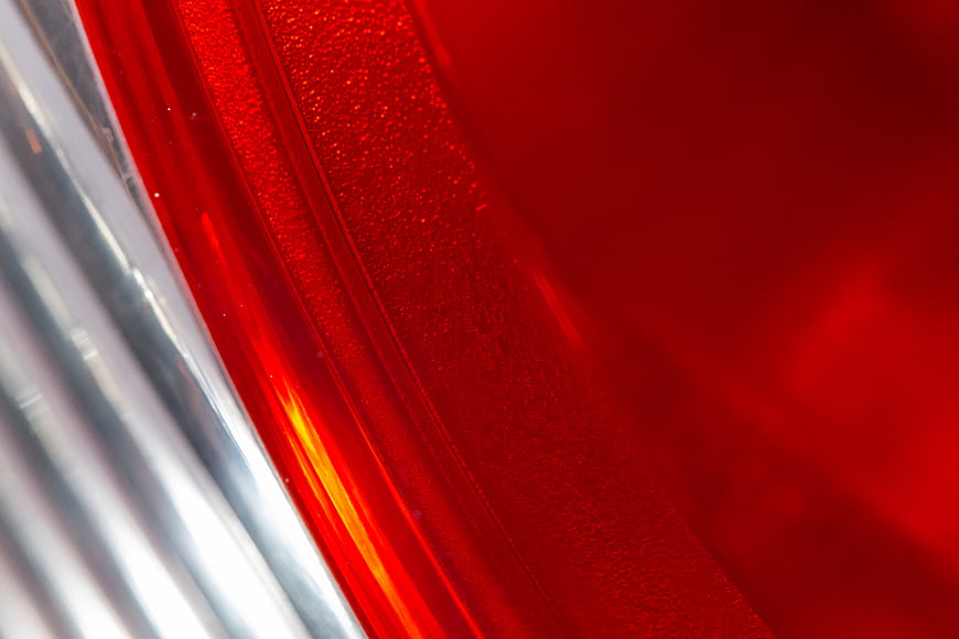 Abstract Close-Up of Red Textured Surface with Chrome Reflection