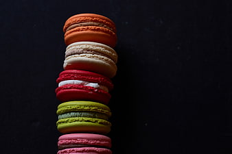 Colorful Macarons Stacked on Dark Background
