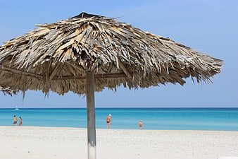 Thatched Beach Umbrella on White Sand with Turquoise Ocean