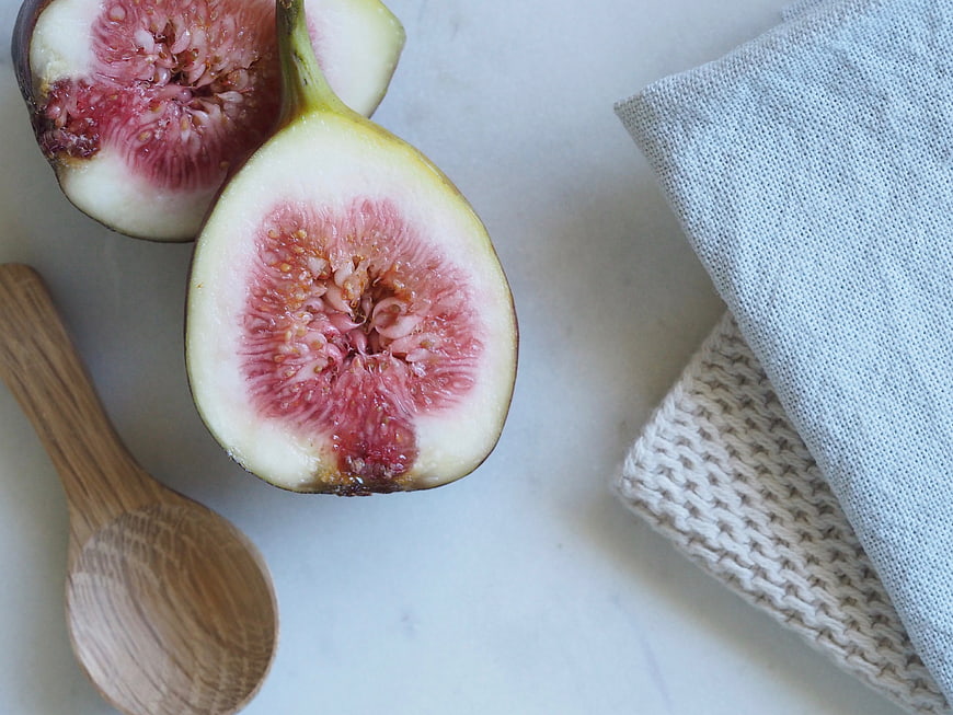 Fresh Sliced Figs Flat Lay with Wooden Spoon and Linen