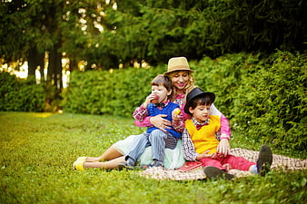 Mother and Two Sons Having a Picnic in the Park