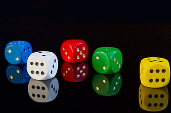 Colorful Dice on Black Reflective Surface